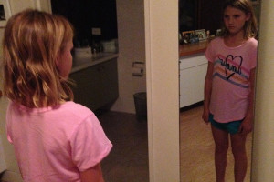 Ava Kaplan glaring at herself through the mirror.