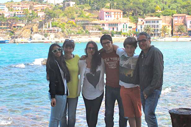 Joana Ospina smiles in front of beautiful France with her last host family.