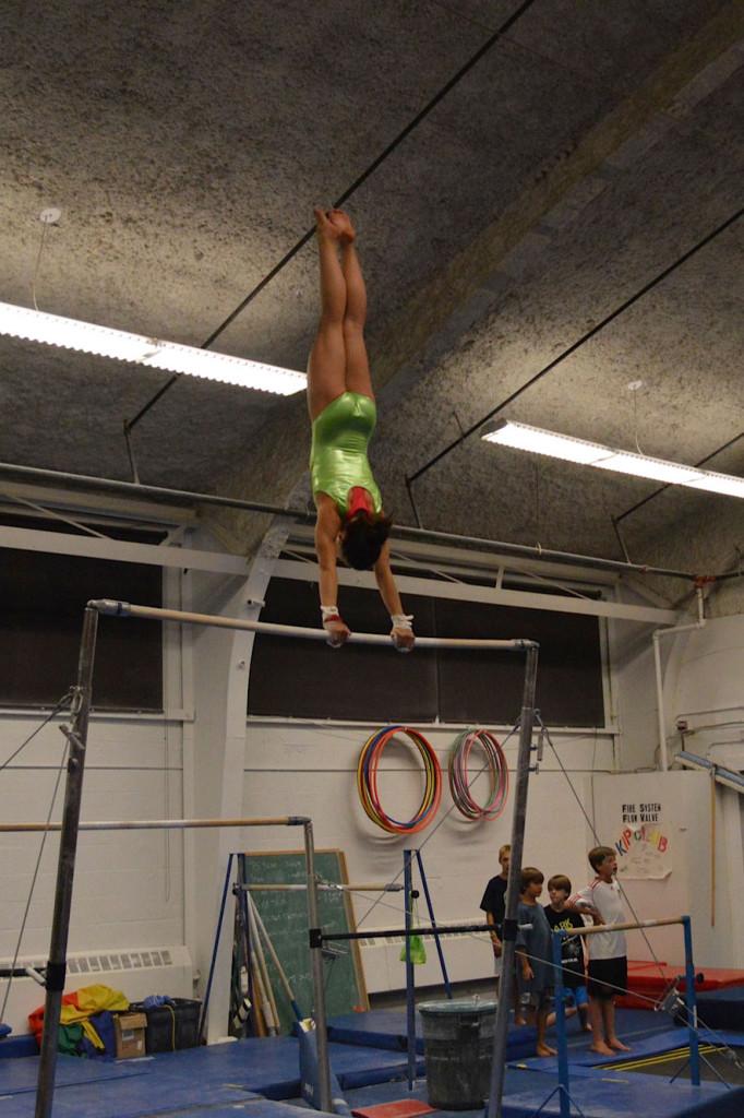 Cheo does giants on the bars during her four hour practice.
