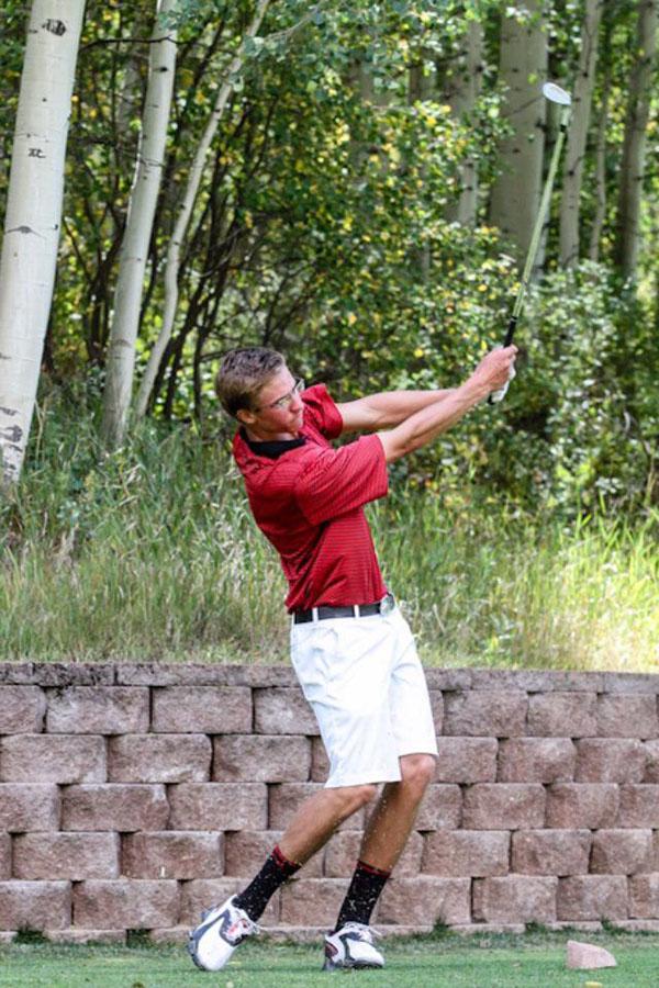 Clayton Crawford tees off on a local course in preperation for the State Golf Tournament.