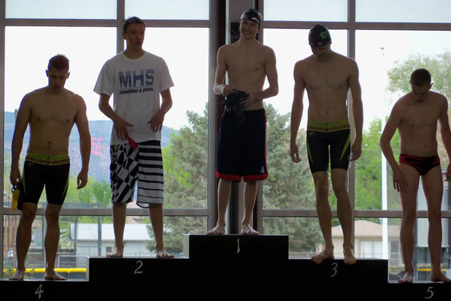 Bryant+stands+atop+the+podium+after+winning+the+200+butterfly+state+championship.