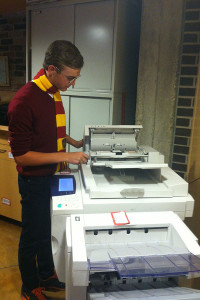 Sophomore Henry Godfrey hurries to fix the printer jam. 