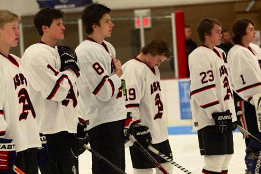 Last years boys hockey team lines up for the National Anthem before a game.  