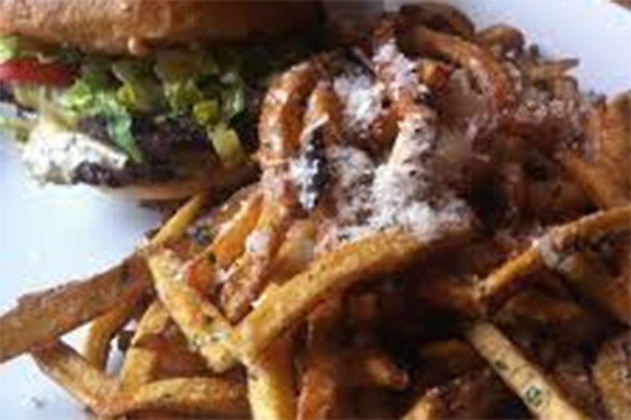 The legendary Ajax Double Cheeseburger and truffle fries displayed at Ajax Tavern.  