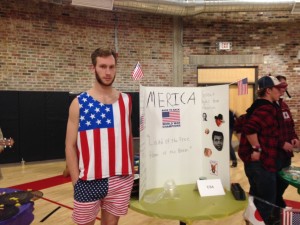 Senior Trent Lichtenwalter stands as a proud American in front of his 'Merica booth while serving peach pie.