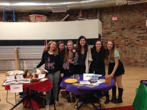Juniors Julia Budsey, Sonya Padden, Bentley Rager, Isabelle Wolfer, Maria King, and Megan Hansen give out food from Sweden and Russia during the Cultural Carnival.