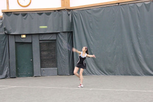 Number three singles player Caroline DeRosa returns a serve in her match Saturday. 