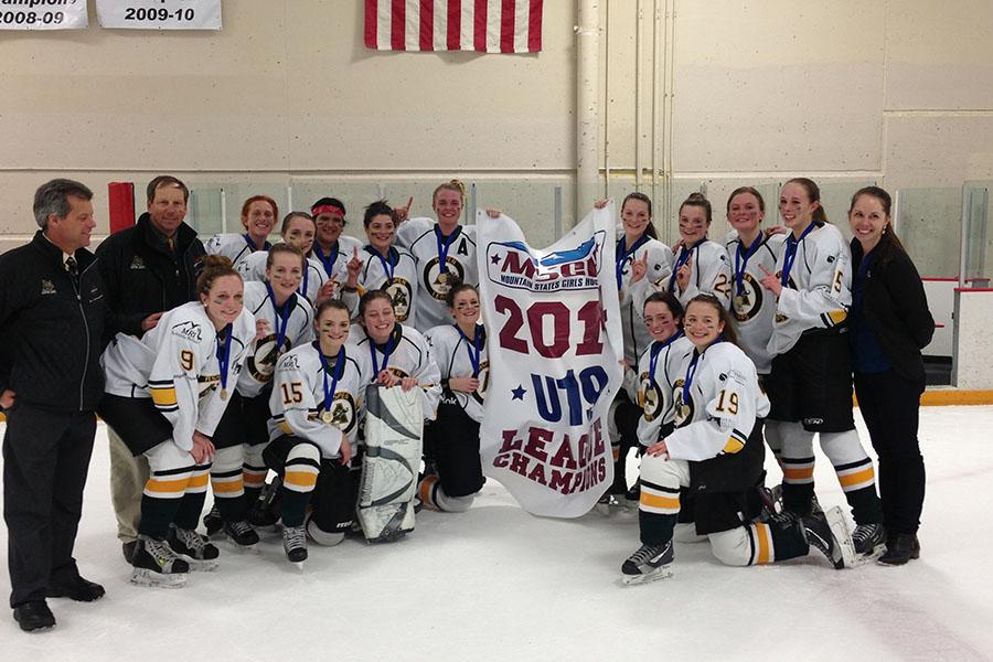 The Aspe Leafs Girls U-19 team poses with their banner after winning the state championship game.