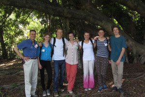 The students, along with Campo, take a break from working in the shade of a large tree. 