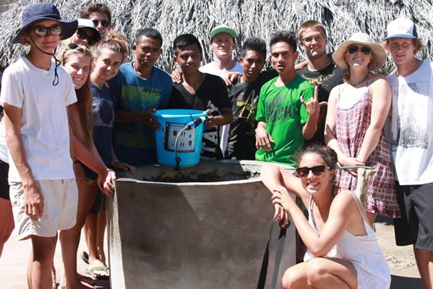 The H20 Club members pose with one of the water filters they helped install in Indonesia. 