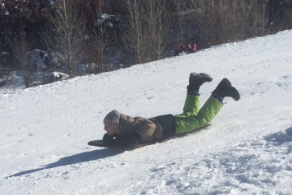 Local Aspen kid, Lucas Lee, enjoys a sunny day of sledding over Thanksgiving Break at the Whoa Nelly Sledding Hill next to the ARC