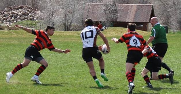 The Junior Gents hustle towards the rugby ball mid-game. 