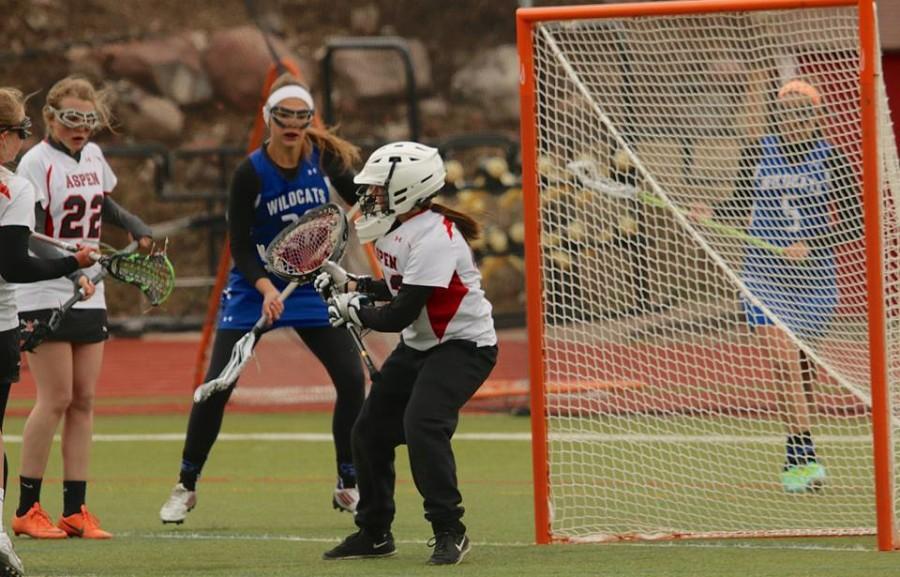 Junior Hannah Clauss saves a goal during the send half of the game. 