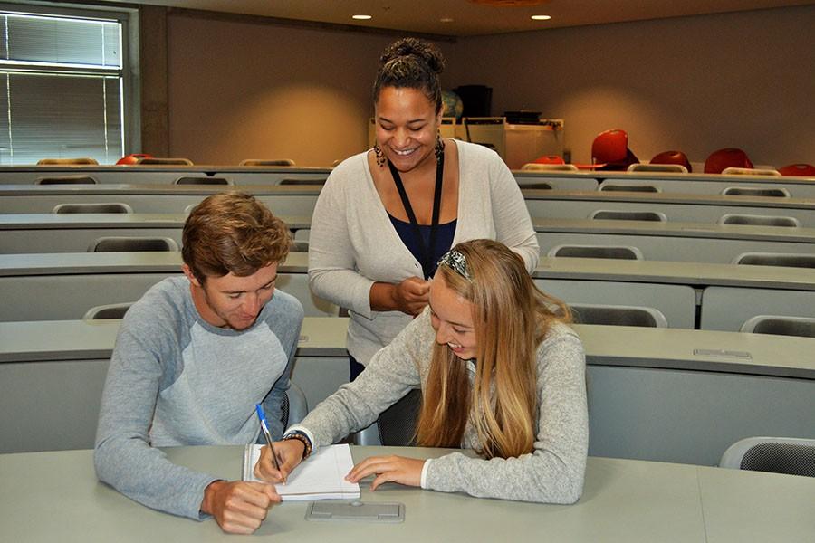 Victor Dunn and Anna Belinski meet with Tameira Wilson during a student senate meeting.