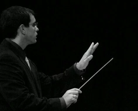 AHS music teacher Jeff Loda conducts a musical ensemble.
