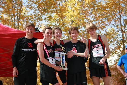 The boys proudly hold the first place trophy for the annual Chris Severy Cross Country Race. 