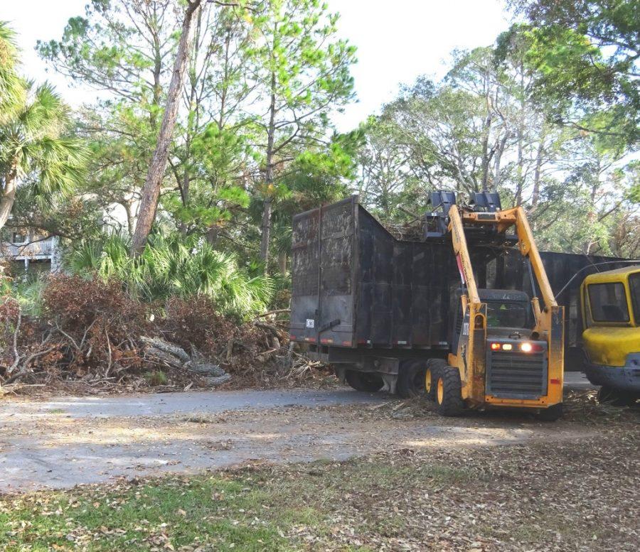 Dump trucks are picking up debris on Fripp Island, South Carolina.