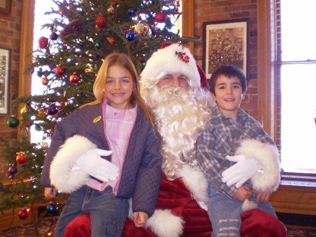 The author, Chelsea Moore, and brother Taiga Moore sit on Santas lap many years ago. 