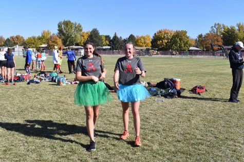 Sophomores Kyley Grogan and Greta Hansen having fun at a XC meet.