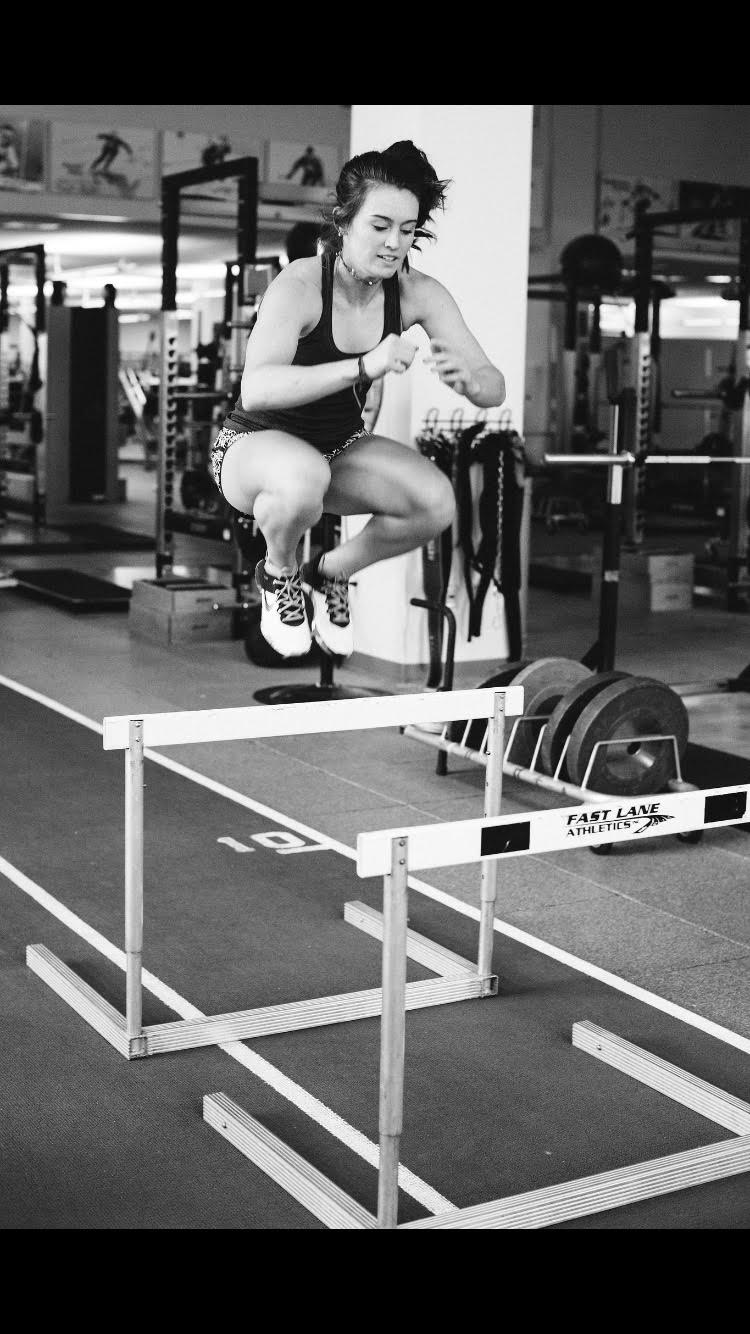 Galena Wardle jumping over hurdles in the gym as she continues her recovery.