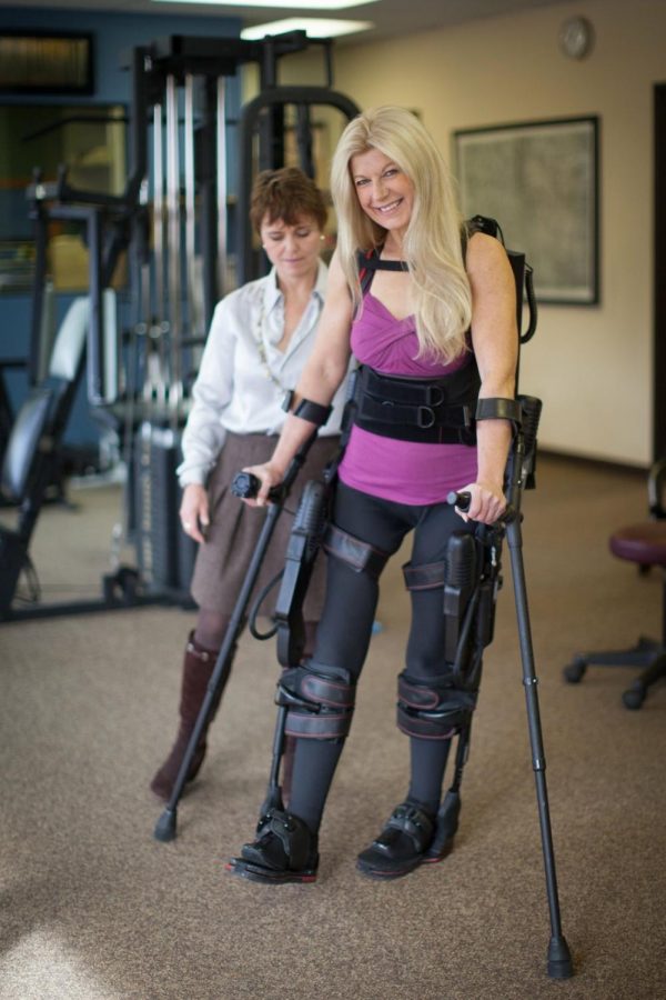 Amanda Boxtel using the exoskeleton to walk 