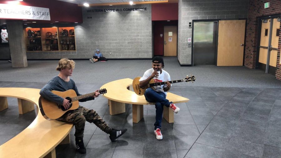 Two band students practicing the guitar.