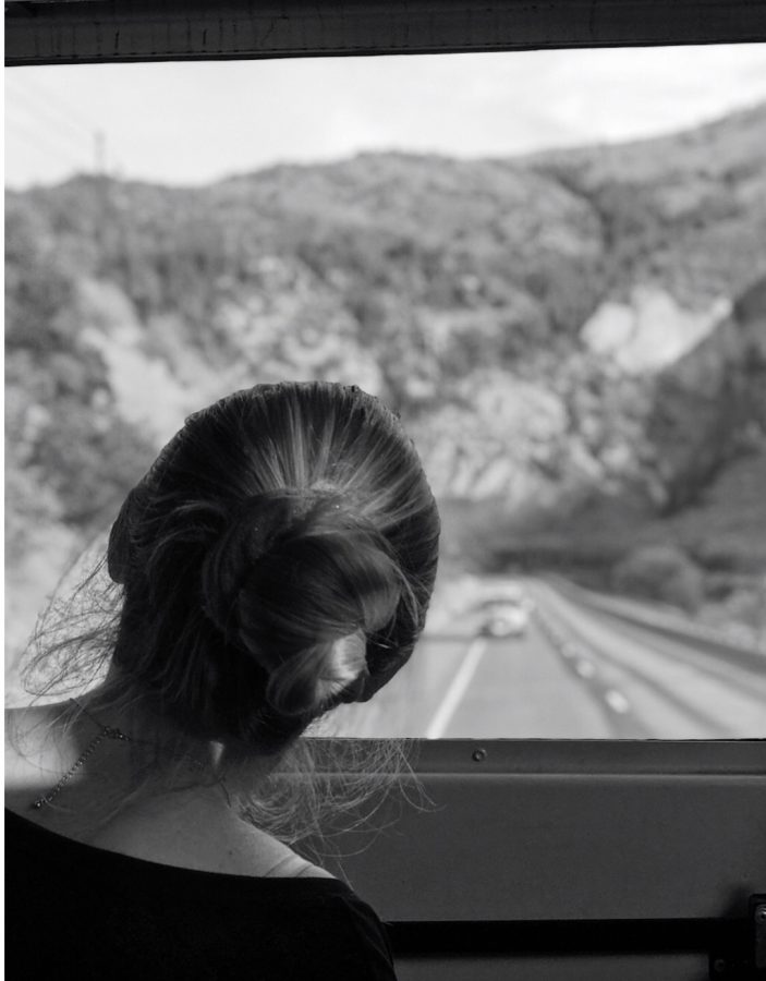 AHS student staring into the abyss of the Glenwood Canyon on the back of a school bus.