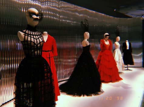 Edgy lineup of red, black, and white couture outfits in the