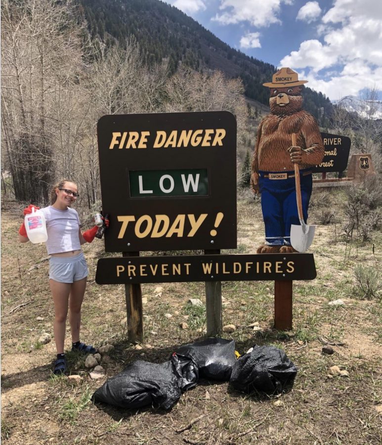 AHS junior, Olivia Burkley, posing next to fire danger sign on Independence Pass during the Guatemala Literacy Club’s trash cleanup on May 4, 2019.