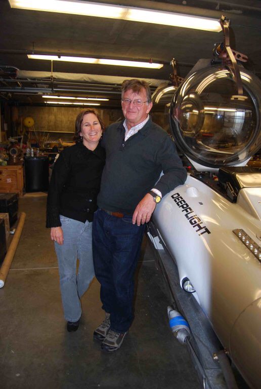 Karen (left) and Graham (right) Hawke posing with the Deep Flight submarine.