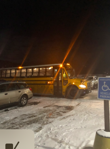 A school bus returns from a ski race in Beaver Creek at night.