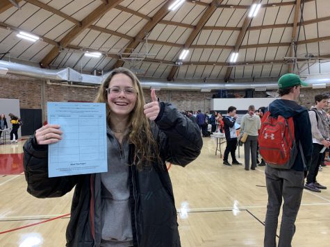 Junior Maggie Woodrow learns about possible IB classes at the IB Fair on Febuary 4th.