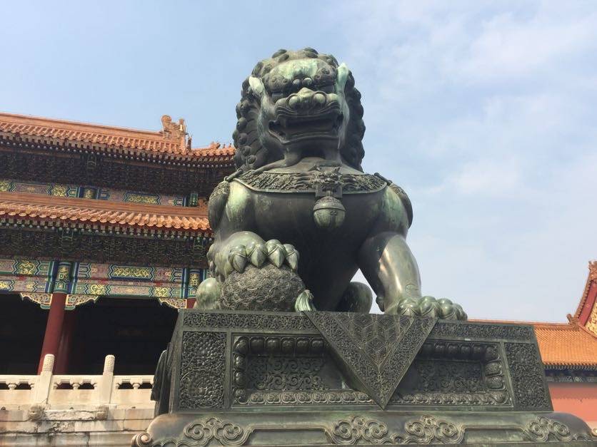 A statue of an animal guardian standing outside of the Forbidden City in Beijing, China.