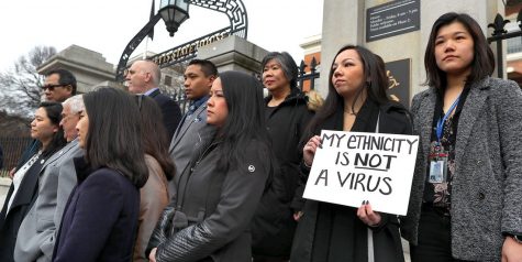Members of the Asian-American Commission on the steps of the Massachusetts State House protesting the racism toward Asian-Americans as a result of COVID-19.