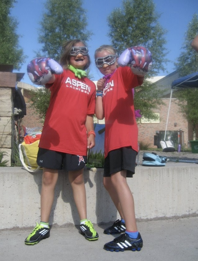 Senior Womens Lacrosse team players, Hannah Zanin and Lauren Fox, posing for a photo at a lacrosse game when they were younger. 