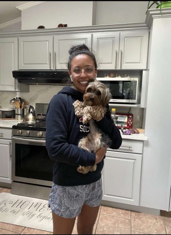 Karen Galvan holds her Yorkie Terrier, Mango, in her house during quarentine.