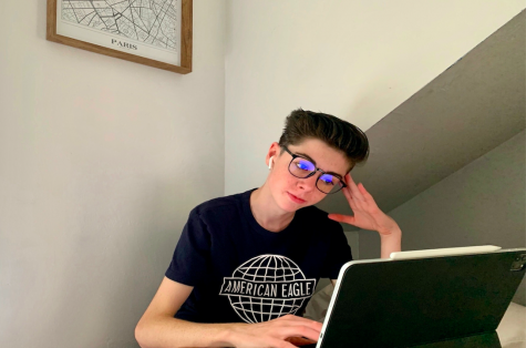 Bridger Thompson looks at his screen during online learning with his blue light glasses.
