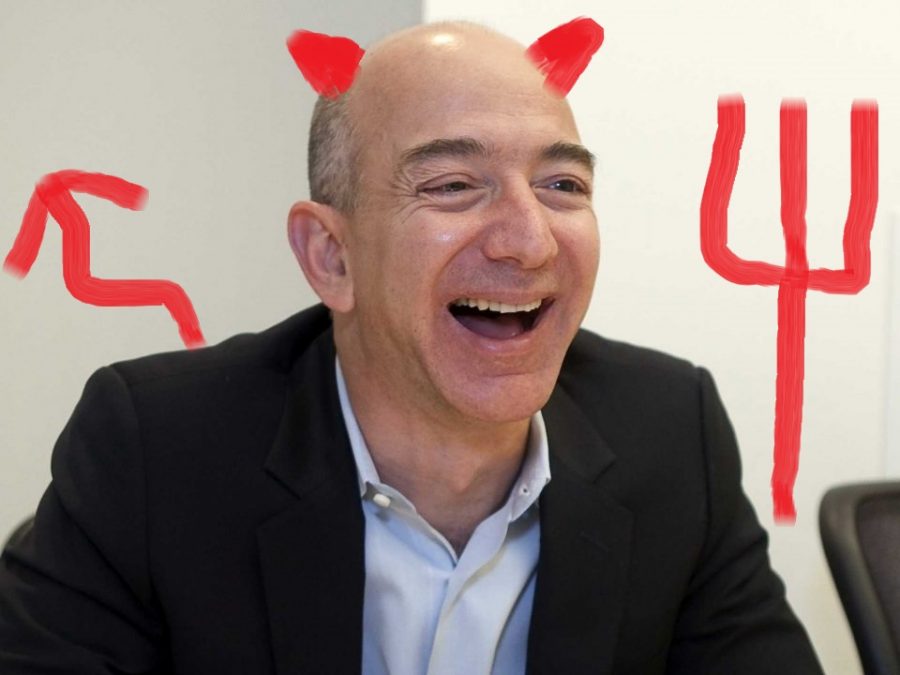 Jeff Bezos with devil horns and a tail drawn on him.