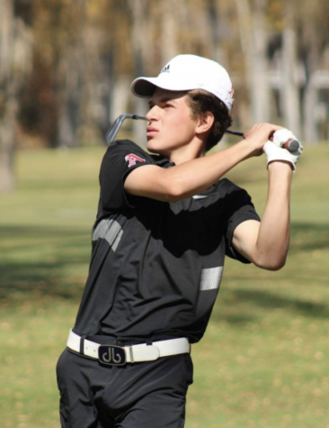 Nic Pevny at the end of his golf swing during the state championship tournament.