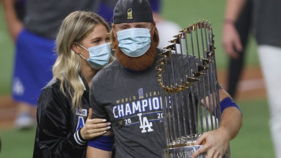 Justin Turner holding World Series trophy after win. 