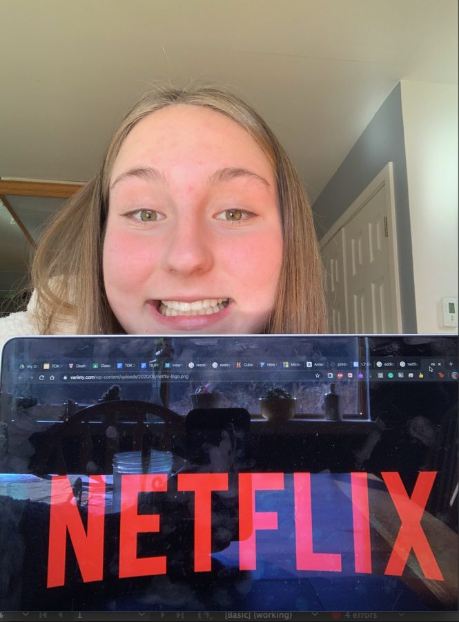 Emily Kinney, senior, smiling as Netflix opens on her computer.