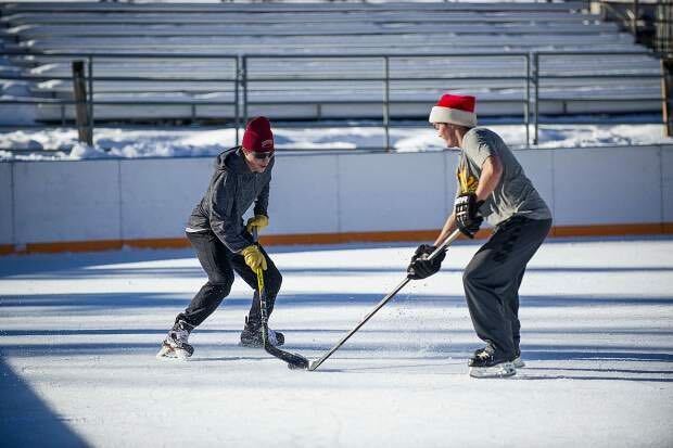 Two hockey players on Snowmass Villages ice skating rink