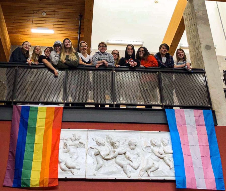 Aspen+High+School+Gay-Straight+Alliance+club+gathers+around+pride+flags+hanging+in+the+lobby+of+AHS.