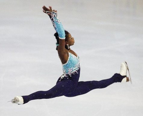 Surya Bonaly performs a split jump.