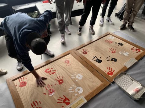 Seniors print their hands onto Huggards Eagle Project on December 15th.