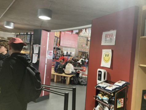 AHS students standing in line in front of anti-theft signs at the cafe during their lunch.