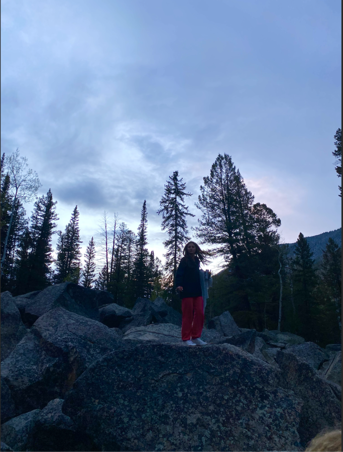 Gracen Rogers stands on a rock at sunset