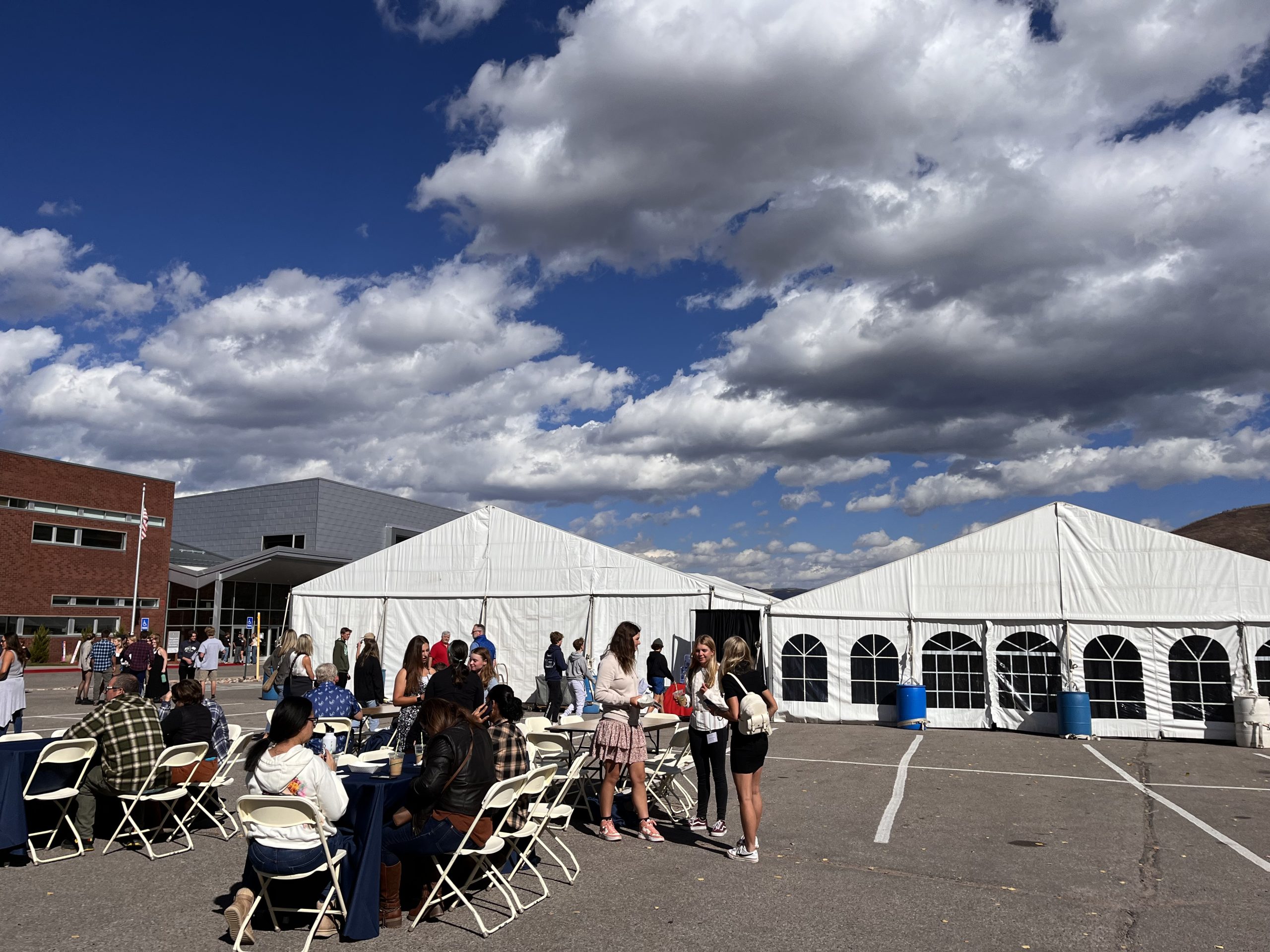 Students and families from all over the Western Slope gather at the Aspen Middle School parking lot on October 1st, 2023 to talk to the numerous college reps inside the white tents.