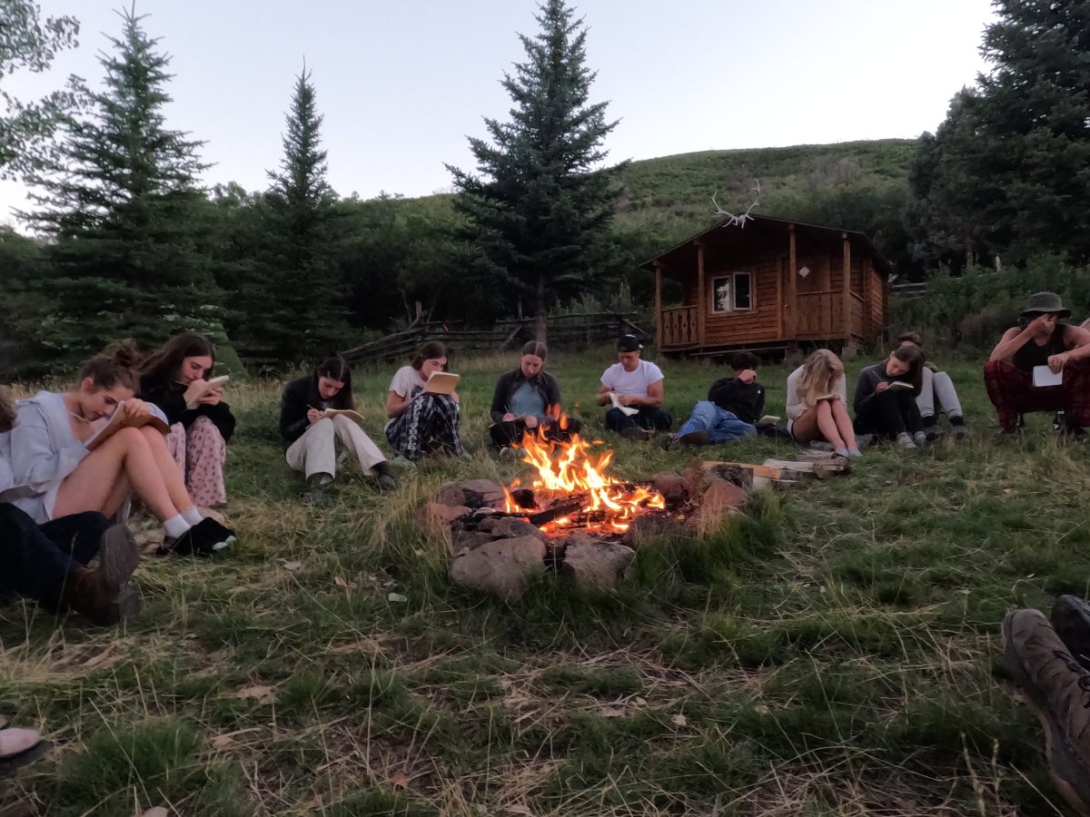 AHS+Students+gathered+around+the+campfire+journaling+during+the+Bair+Ranch+Ex-Ed+program.