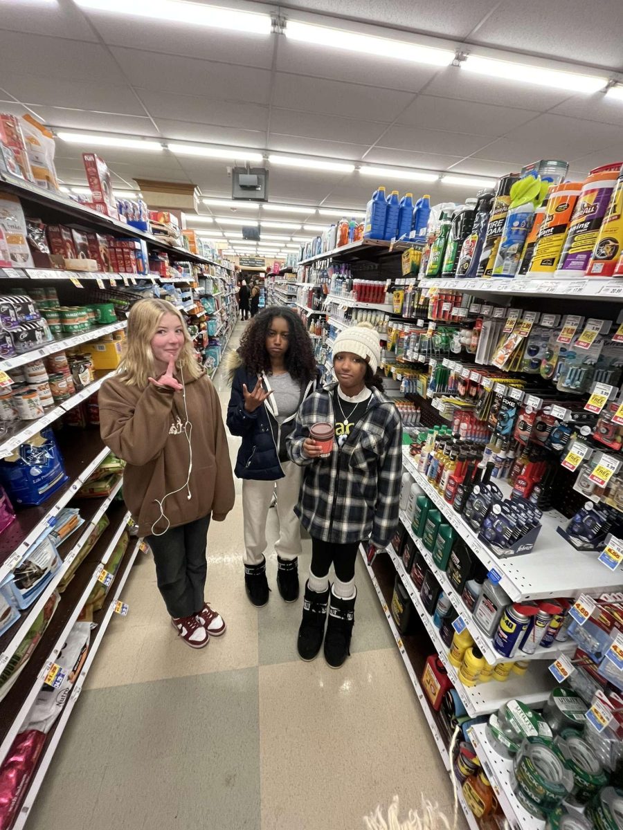 Teens pose for a photo in City Market, wearing Moon Boots.